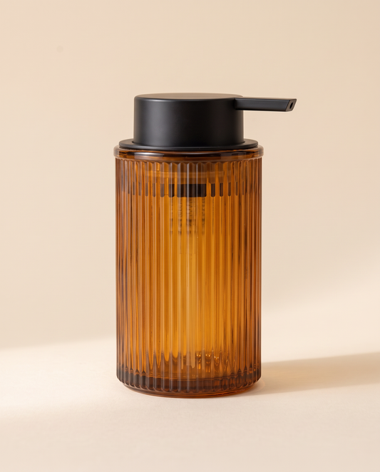 Ribbed amber glass foaming soap dispenser with a matte black pump